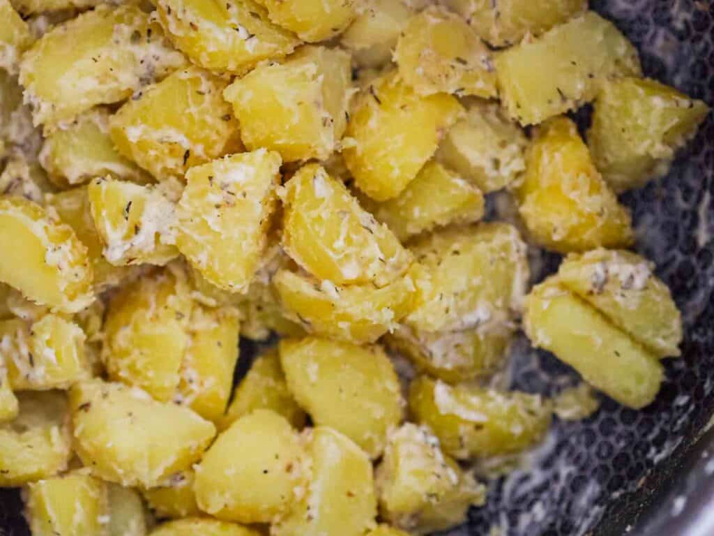 close up bowl of garlicky roasted potatoes before oven